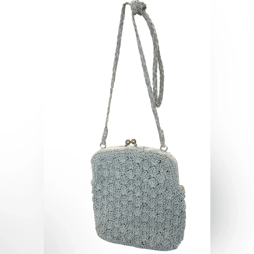 crocheted evening bag with a metal kiss-lock closure and braided shoulder strap